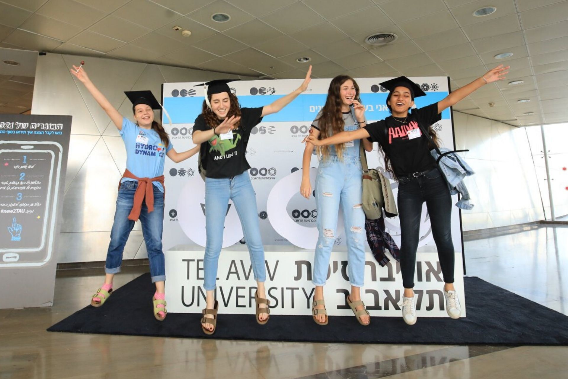 TAU students jumping at graduation